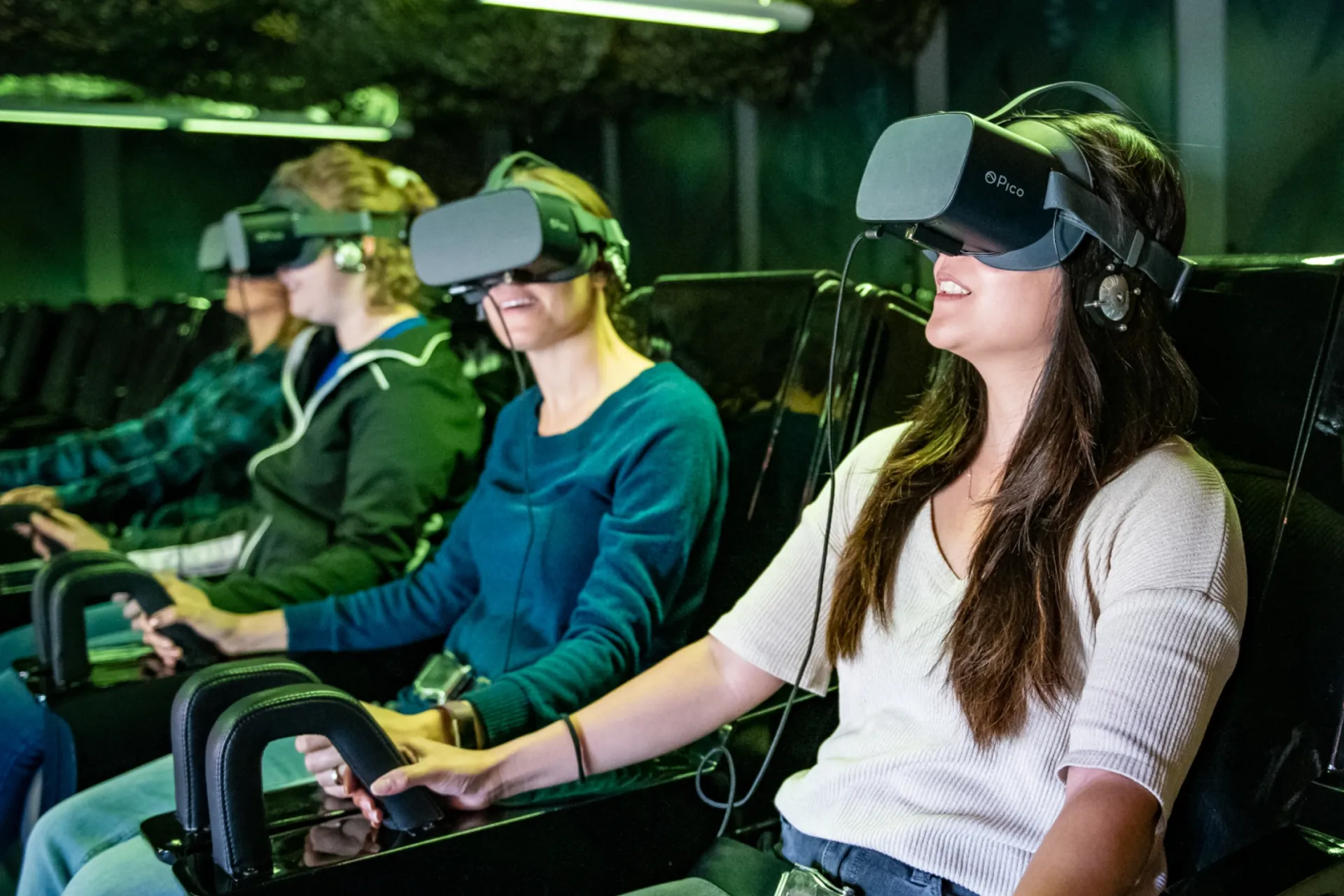 A group of people wearing VR head sets and enjoying a VR theater experience.